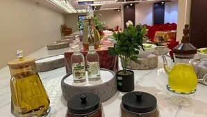 A table with various glass containers and a potted plant. - Retaj Alhayat (Makkah)