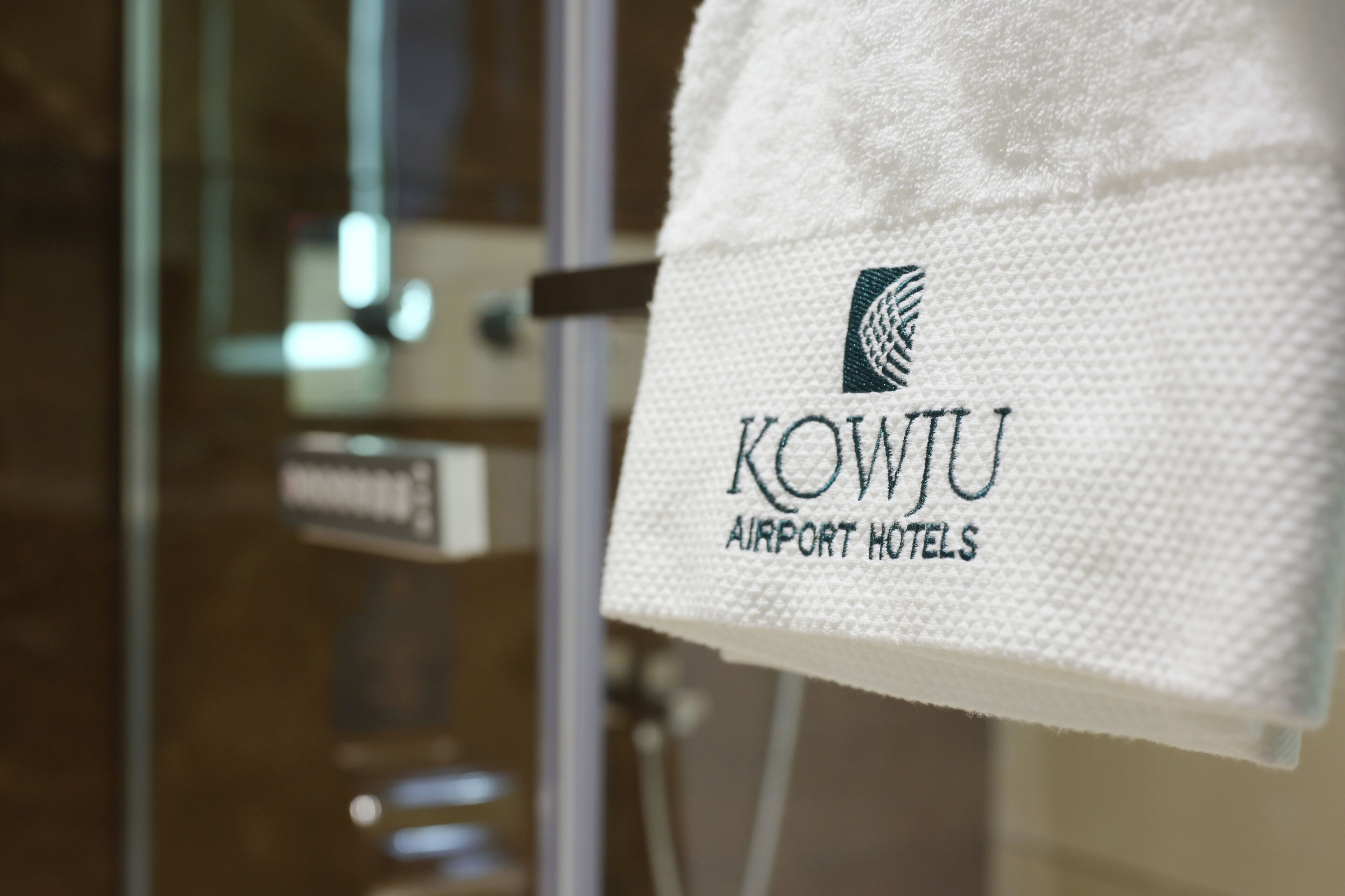 A towel with the logo and name of KOWJU Airport Hotels.