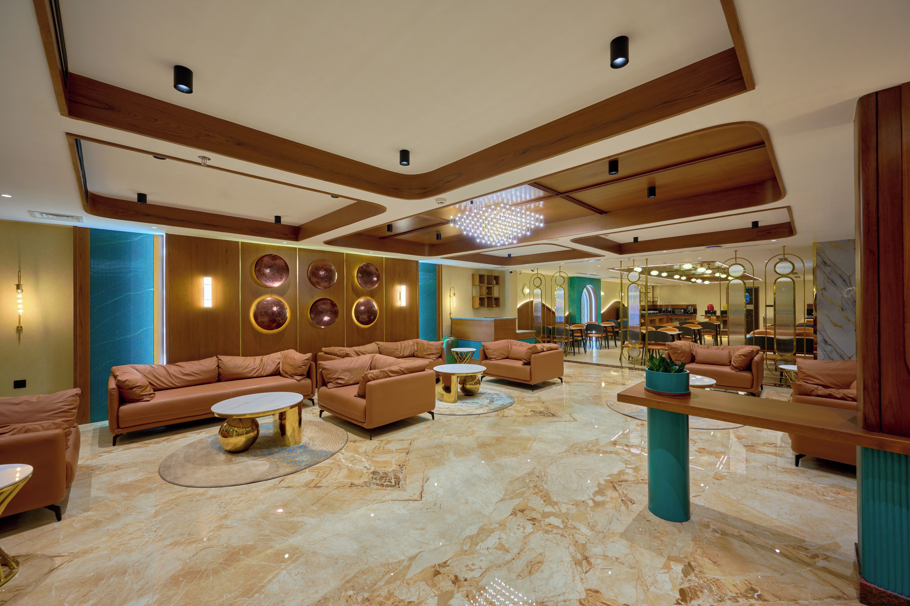 A spacious lobby with a marble floor, multiple sofas, and a central coffee table.