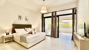 A bedroom with a bed, nightstands, a TV, and a balcony with curtains.