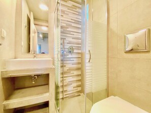 A modern bathroom with a glass-enclosed shower, a white sink, and a mirror. - Barbati Beta MiniVilla with pool (Barbati)