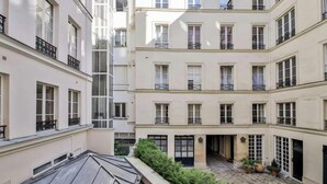 A multi-story building with balconies and a courtyard. - A SERENE RETREAT & COMBINATION OF LUXURY, COMFORT, AND LOCATION-SAINT GERMAIN (Paris)