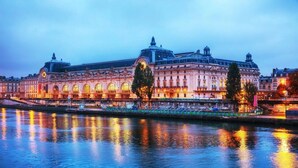 A historic building with arched windows and a central dome, reflecting on a calm body of water. - A SERENE RETREAT & COMBINATION OF LUXURY, COMFORT, AND LOCATION-SAINT GERMAIN (Paris)