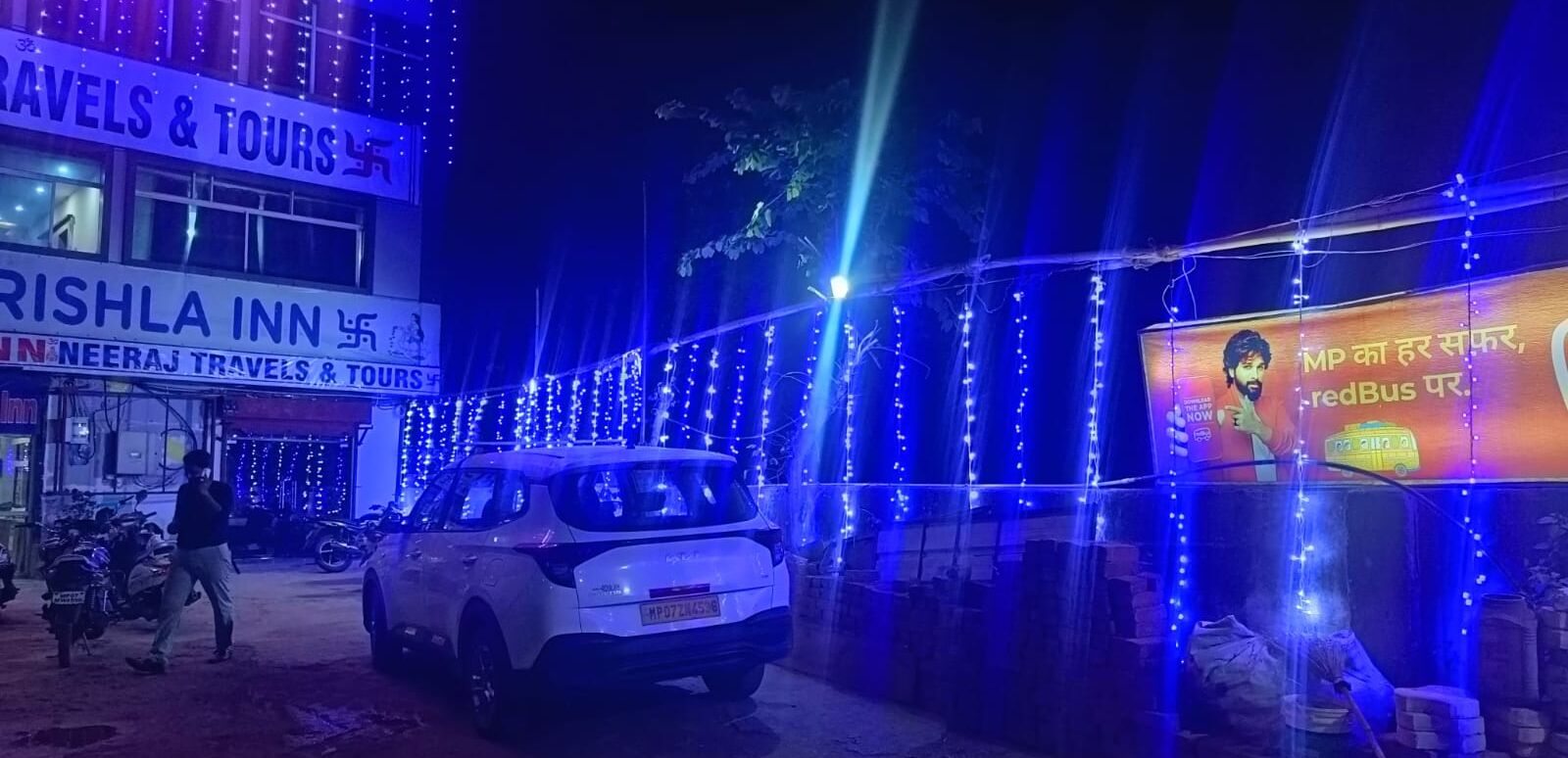 A building with signage for 'Rishla Inn' and 'Neeraj Travels & Tours'.