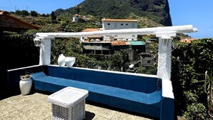 A rooftop terrace with a white pergola, a small white table, and a potted plant. - Holiday Home in Porto da Cruz With Garden (Machico)