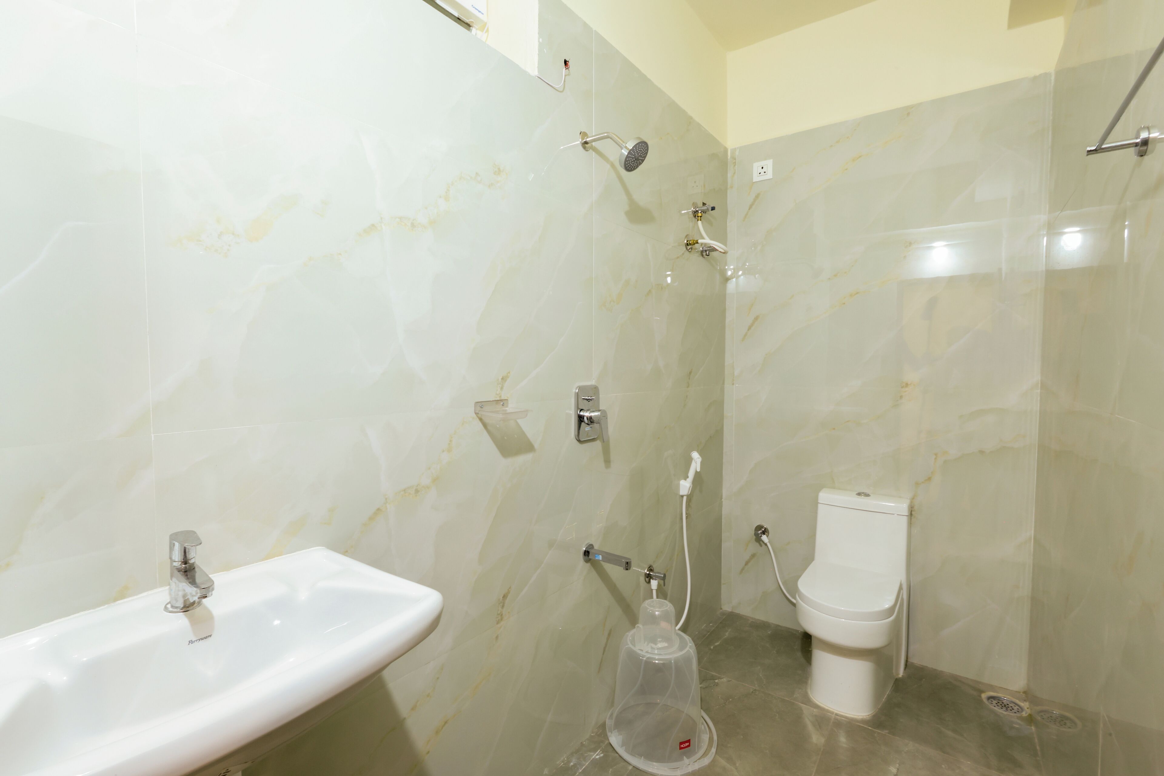 A bathroom with a sink, toilet, and shower.