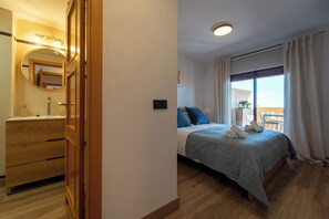 Relax in a spacious room with a large bed, dresser, and mirror.