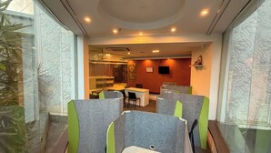 A modern office space with cubicles, a reception area, and a dining area. - C Suite - Lotus park (Bengaluru)