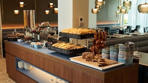 A buffet counter with various food items and a coffee station. - Hotel Le Parc (Wiener Neustadt)