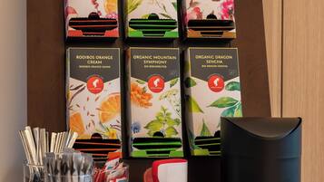 A display of organic tea boxes and a mug on a wooden shelf.