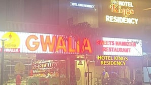 A building with a neon sign reading 'HOTEL KINGS RESIDENCY' and a bull logo. - Hotel Kings Residency (Ahmedabad)
