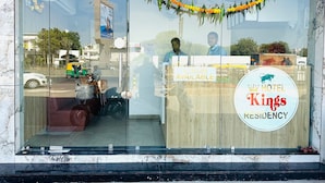 A hotel entrance with a sign reading "HOTEL KINGS RESIDENCY" and a "HOTEL KINGS RESIDENCY" logo. - Hotel Kings Residency (Ahmedabad)