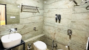 A bathroom with a sink, toilet, bidet, and a towel rack. - Hotel Kings Residency (Ahmedabad)