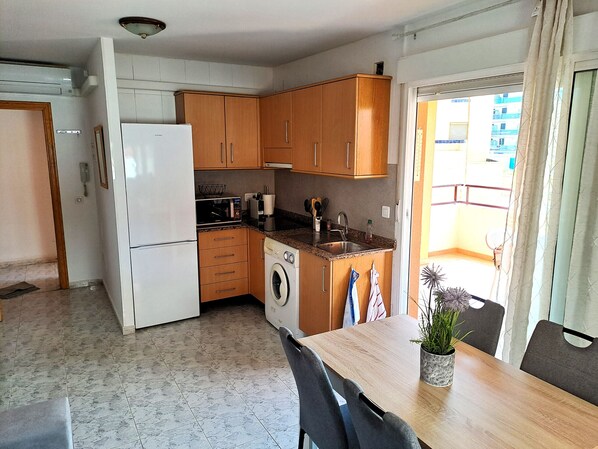 Fridge, microwave, coffee/tea maker, cookware/dishes/utensils