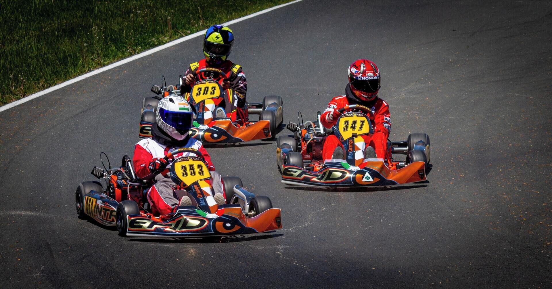 Three go-karts on a race track.