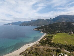 Enjoy breathtaking views of the beach and surrounding fields from this serene coastal location.