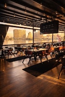 A modern restaurant with a view of a city skyline.