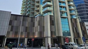 A high-rise building with a modern architectural design, featuring multiple balconies and large windows. - Bespoke Residences - Urban Oasis  (Dubai)