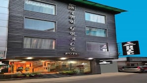 A modern hotel with a vertical sign reading "THE RACE HOTEL".