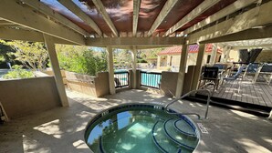 A covered outdoor swimming pool with a 3 FT depth limit sign, surrounded by lounge chairs and a wooden deck. - Gorgeous 2 bedroom villa overlooking Shelter Cove Harbour with pool and spa (Hilton Head Island)