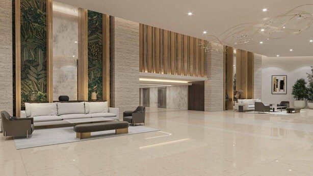 Een ruime lobby met een moderne bank, een zitbank en een receptiehoek.