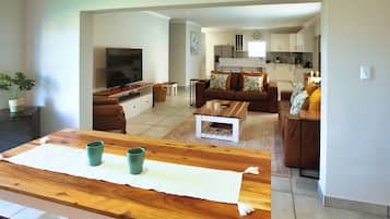 Comfort House, Garden View | Living area | Flat-screen TV