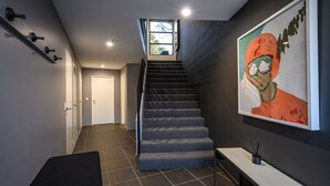 A staircase leading to a second floor with a view of the outdoors.