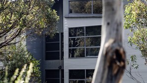A modern building with multiple windows and a metal facade.