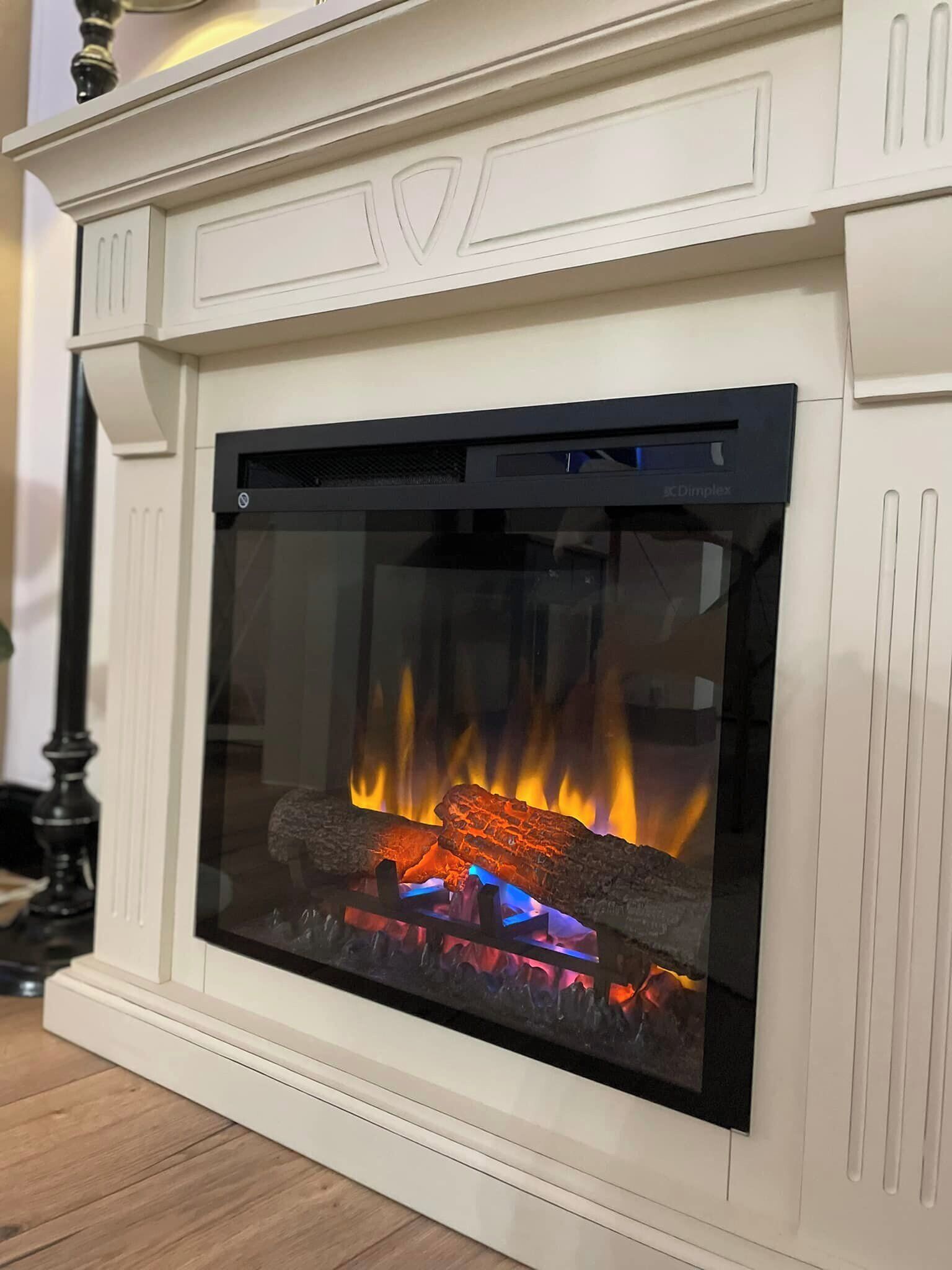 A fireplace with a glass front, displaying a fire.