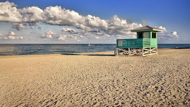 A beach with a lifeguard tower.