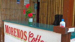 A reception desk with a sign reading "Morenos Cottages". - morenos cottage  (Boracay Island)