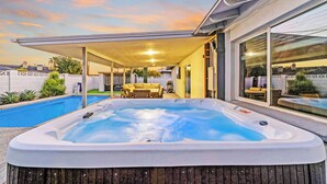 A backyard with a hot tub, a pool, and a covered patio area. - Solace | Pool, Hot Tub, Cabana, Fire Pit, Outdoor Living, Sleeps 22 | Old Town Scottsdale (Scottsdale)