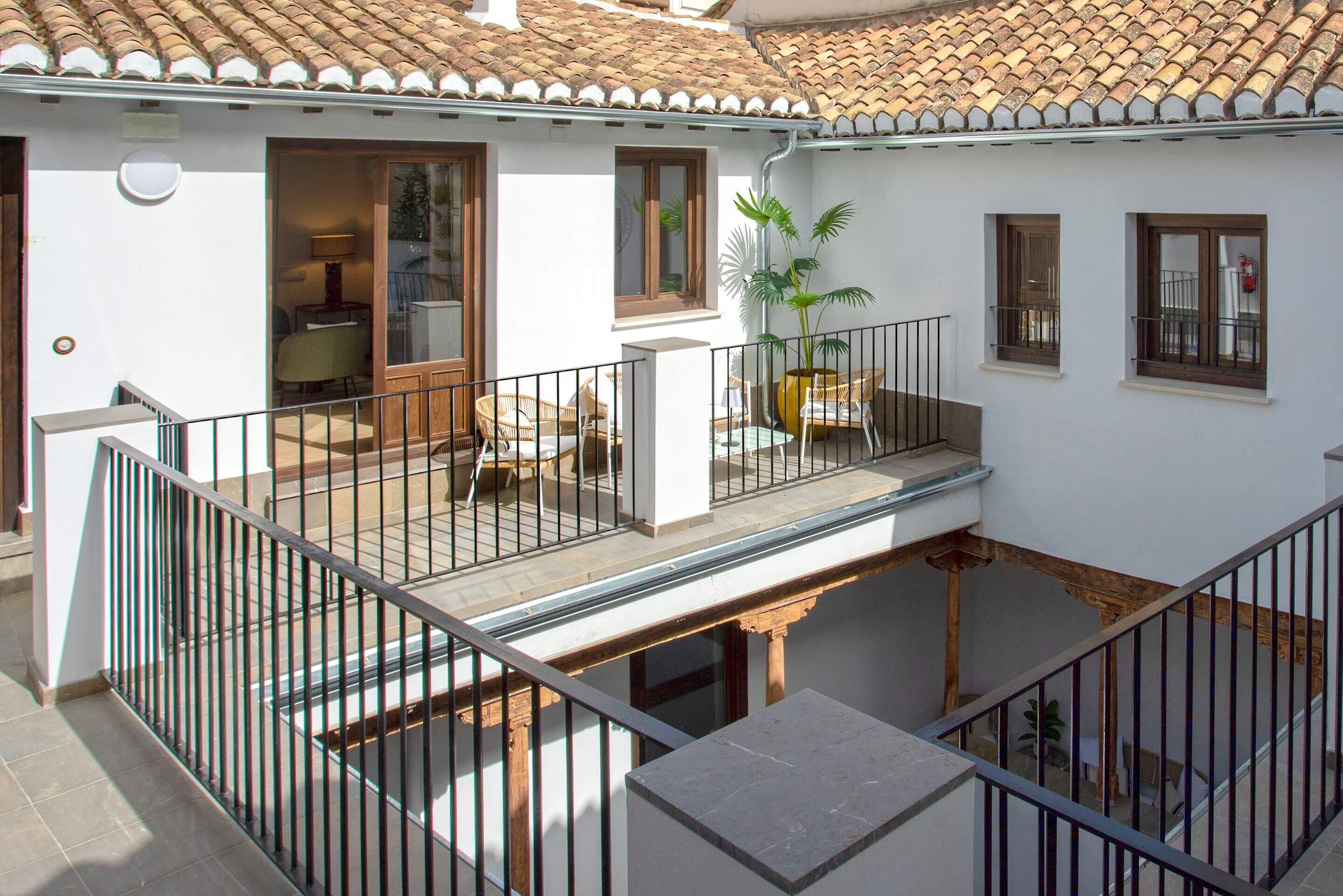 A two-story house with a balcony, a dining area, and a living room.