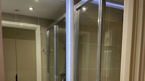 A modern bathroom with a glass shower enclosure, a sink, and a mirror. - The Depot in Bath (Bath)