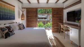 Een slaapkamer met een bed, een bureau en een televisie.