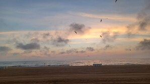 A beach with a wide sandy area and a calm sea. - Modern 2BD/BA, 1.5 Blocks to Sea, Walk to Amenities w/ Pool, Linens & Parking (Virginia Beach)