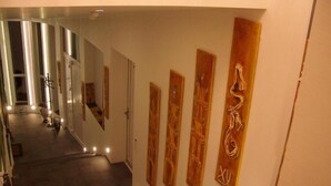 A staircase with wooden steps and wall-mounted artwork. - BLACK&WHITE vacation home (Niederösterreich)
