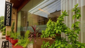 A hotel entrance with a sign reading "HOTEL GOODLCK".