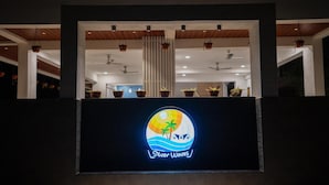 A hotel entrance with a sign reading "Silver Waves." - Silver waves Beach Stay (Udupi)