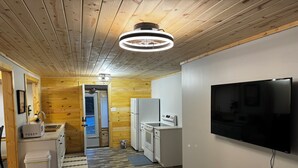 A modern kitchen with a built-in oven, microwave, and refrigerator.