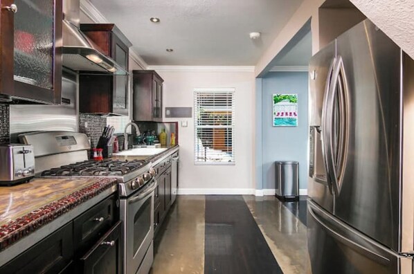 Enjoy cooking in this well-equipped kitchen with a refrigerator, oven, and stove.