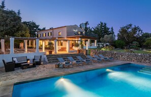 A poolside area with lounge chairs and a swimming pool.