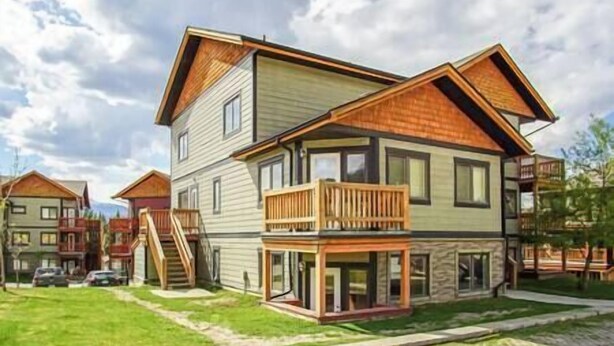 A two-story house with a balcony, a staircase, and a garage.
