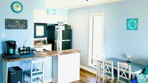 A compact kitchen with a central island, a ceiling fan, and a dining area with a table and chairs. - ♥New Listing Discount♥Ocean View♥Private Deck♥Newly Remodeled (North Topsail Beach)