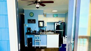A kitchen with a central island, a ceiling fan, and a clock on the wall. - ♥New Listing Discount♥Ocean View♥Private Deck♥Newly Remodeled (North Topsail Beach)
