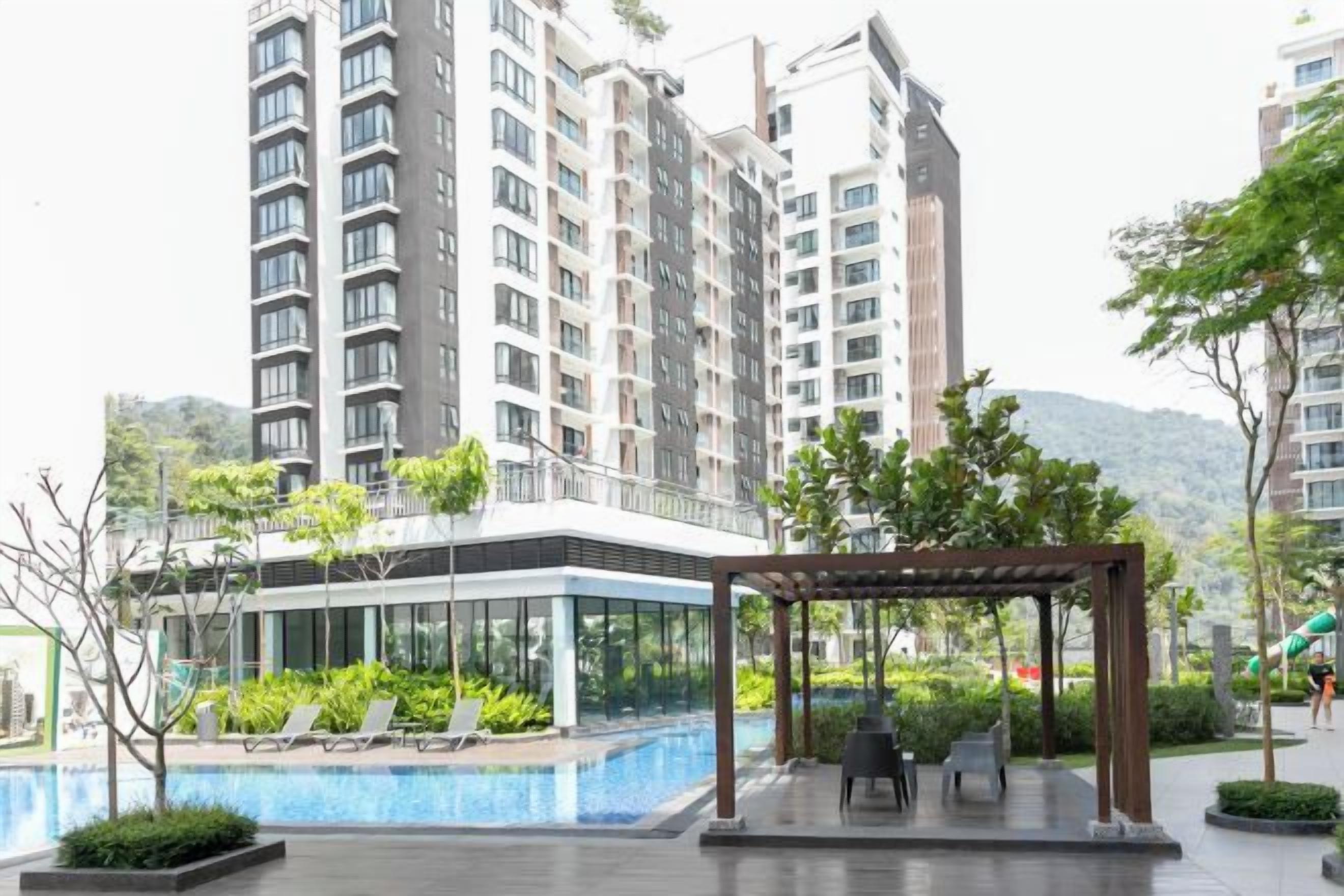 A modern residential building with a rooftop pool, a covered outdoor seating area, and a view of surrounding high-rise buildings.