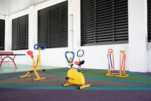 A fitness area with exercise equipment including a stationary bike, a rowing machine, and a leg press. - The Loft@Midhill Genting Highlands (Genting Highlands)