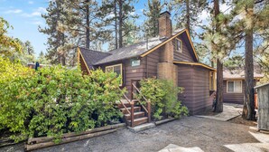 A rustic cabin with a chimney, wooden steps, and a gravel driveway. - Sugar Bear Pines #2493 (Sugarloaf)