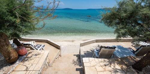 Beachfront villa Mihovil with direct beach access, garden, pool and mooring