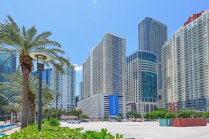 A modern urban area with high-rise buildings, palm trees, and a clear sky. - Brickell Condos Heart of Miami Living (Miami)